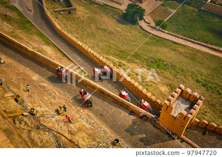 Tourists riding elephants on ascend to Amer fort 97947720