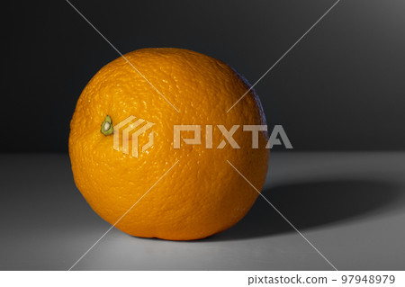 RIPE ORANGE FRUIT HIGHLIGHTED ON A DARK GRAY BACKGROUND RIPE ORANGE FRUIT HIGHLIGHTED ON A DARK GRAY BACKGROUND 97948979