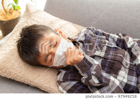 A boy coughing. 97949258