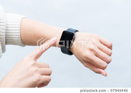 A woman operating a smart watch (diagonal) A woman operating a smart watch (diagonal) 97949446