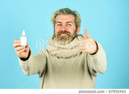 Runny nose recovery. Health care concept. Fast recovery. Cold flu remedies. Runny nose and symptoms of cold. Man scarf hold nasal spray. Medicines effective recovery. Recommended medical treatment Runny nose recovery. Health care concept. Fast recovery. Cold flu remedies. Runny nose and symptoms of cold. Man scarf hold nasal spray. Medicines effective recovery. Recommended medical treatment 97950403