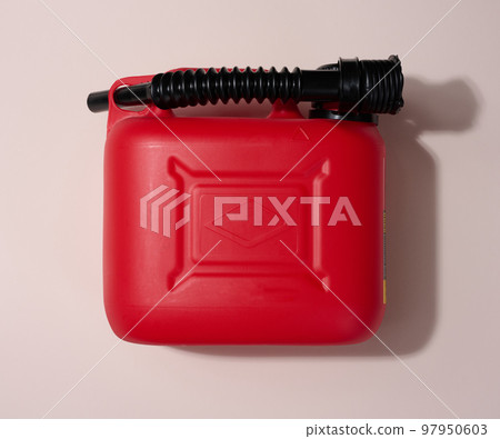 Red plastic canister for liquid fuels and lubricants on a beige background Red plastic canister for liquid fuels and lubricants on a beige background 97950603