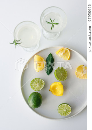Lemon and lime citrus lemonade. Cooking process in a bright kitchen close-up Lemon and lime citrus lemonade. Cooking process in a bright kitchen close-up 97950666