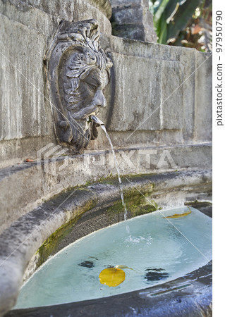 Faun head sculptue as part of medieval fountain at Plaza del Espiritu Santo in Vegueta, Las Palmas de Gran Canaria, Spain 97950790