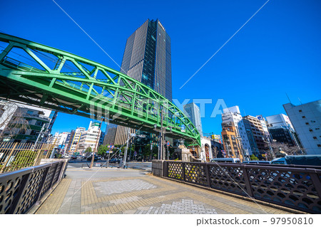 Tokyo cityscape of Japan: View of the Sobu Main Line Matsuzumicho Overpass and skyscrapers from Shoheibashi to the Shoheibashi intersection Tokyo cityscape of Japan: View of the Sobu Main Line Matsuzumicho Overpass and skyscrapers from Shoheibashi to the Shoheibashi intersection 97950810
