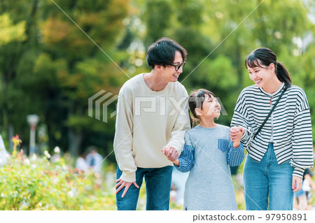 Family walking in the park together 97950891