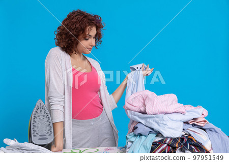 Hard and monotonous work at home while ironing clothes. Hard and monotonous work at home while ironing clothes. 97951549