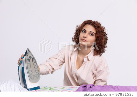 Boring household chores. Pause while ironing men's shirts. 97951553