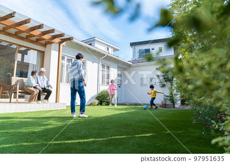 Three generation family playing in the garden Three generation family playing in the garden 97951635