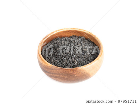 Wooden bowl with black salt isolated on white background. Wooden bowl with black salt isolated on white background. 97951711