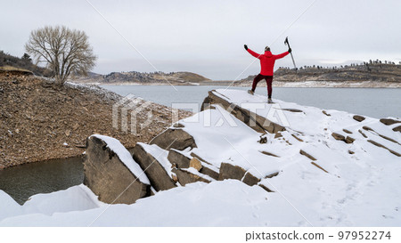 happy hiker on a shore of mountain lake 97952274