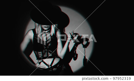 sexy slave girl in underwear and hat holds handcuffs in hands. Concept of BDSM submissive woman sexy slave girl in underwear and hat holds handcuffs in hands. Concept of BDSM submissive woman 97952319