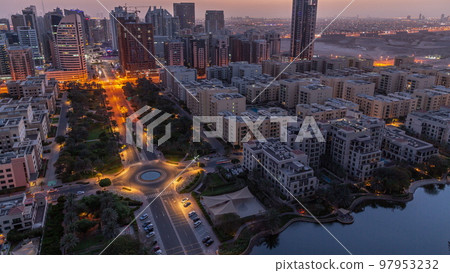 Skyscrapers in Barsha Heights district and low rise buildings in Greens district aerial night to day timelapse. 97953232