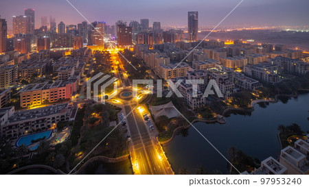 Skyscrapers in Barsha Heights district and low rise buildings in Greens district aerial night to day timelapse. 97953240