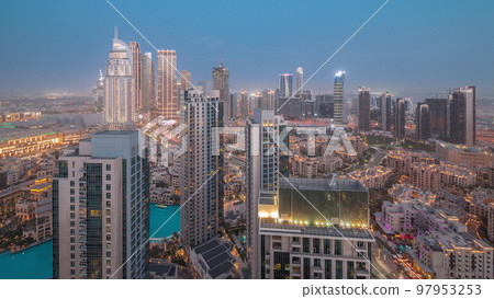Aerial view of a big futuristic city day to night timelapse. Business bay and Downtown 97953253
