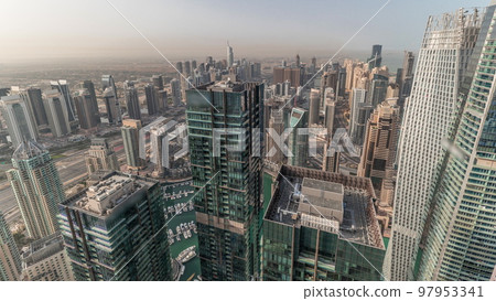 Panorama showing Dubai Marina and JLT with JBR district. Ttraffic on highway between skyscrapers aerial timelapse. 97953341