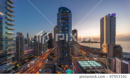 Panoramic view of the Dubai Marina and JBR area and the famous Ferris Wheel aerial day to night timelapse Panoramic view of the Dubai Marina and JBR area and the famous Ferris Wheel aerial day to night timelapse 97953392