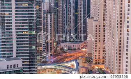 Overview to JBR and Dubai Marina skyline with modern high rise skyscrapers waterfront living apartments aerial night to day timelapse Overview to JBR and Dubai Marina skyline with modern high rise skyscrapers waterfront living apartments aerial night to day timelapse 97953396