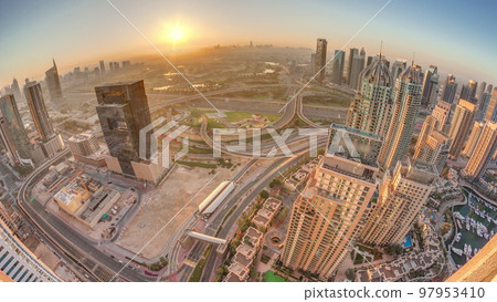 Sunrise over Dubai marina and JLT skyscrapers along Sheikh Zayed Road aerial timelapse. 97953410