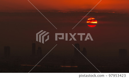 Sunrise over greens and al barsha heights district area night to day timelapse from Dubai marina. Sunrise over greens and al barsha heights district area night to day timelapse from Dubai marina. 97953423