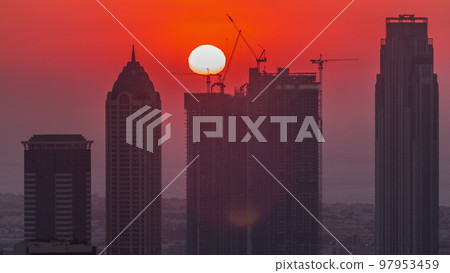 Skyline with modern architecture of Dubai business bay towers at sunset timelapse. Aerial view 97953459