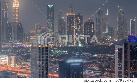 Rows of skyscrapers in financial district of Dubai aerial day to night timelapse. Rows of skyscrapers in financial district of Dubai aerial day to night timelapse. 97953475