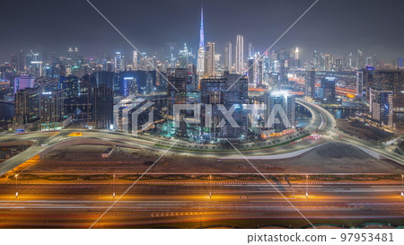 Panoramic skyline of Dubai with business bay and downtown district night timelapse. 97953481