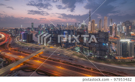 Skyline with modern architecture of Dubai business bay towers day to night timelapse. Aerial view 97953482