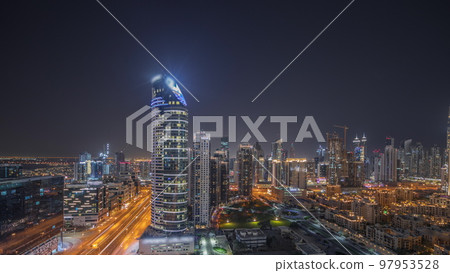 Panorama showing Dubai's business bay towers aerial night timelapse. Rooftop view of some skyscrapers 97953528