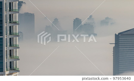 Dubai Aerial view showing fog over al barsha heights and greens district area timelapse Dubai Aerial view showing fog over al barsha heights and greens district area timelapse 97953640