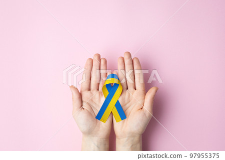 ukrainian ribbon lies on female palms 97955375