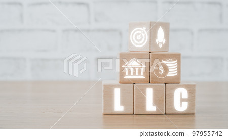 Limited Liability Company (LLC) Business Concept, Wooden block on desk  with limited liability company icon on Vr screen. 97955742