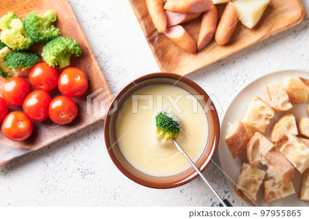 Cheese fondue dipped in broccoli cheese 97955865