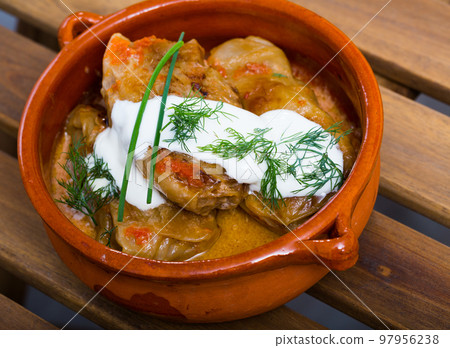 Cabbage rolls in cabbage leaves in clay pot, dish of european cuisine 97956238