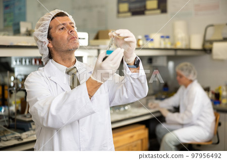 Portrait of an adult male using equipment to work in a laboratory Portrait of an adult male using equipment to work in a laboratory 97956492