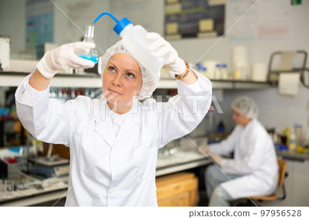 Young adult woman lab technician at work 97956528