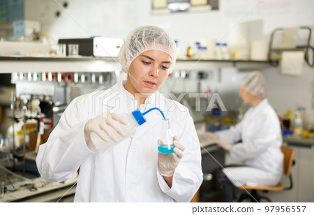 Portrait of young woman lab technician working Portrait of young woman lab technician working 97956557