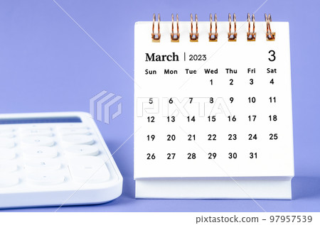 The March 2023 Monthly desk calendar for 2023 year with calculator on purple background. The March 2023 Monthly desk calendar for 2023 year with calculator on purple background. 97957539