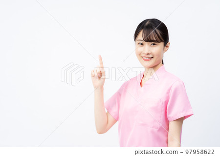 A young female nurse wearing a pink scrub (pointing pose) 97958622