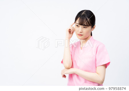 A young female nurse wearing a pink scrub (worried, troubled) 97958874