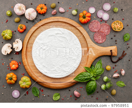 The ingredients for homemade pizza set up on dark stone background. 97958951