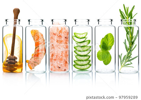 The glass bottle of homemade skin care and body scrubs with natural ingredients aloe vera ,himalayan salt ,peppermint ,rosemary ,turmeric and honey isolate on white background. The glass bottle of homemade skin care and body scrubs with natural ingredients aloe vera ,himalayan salt ,peppermint ,rosemary ,turmeric and honey isolate on white background. 97959289