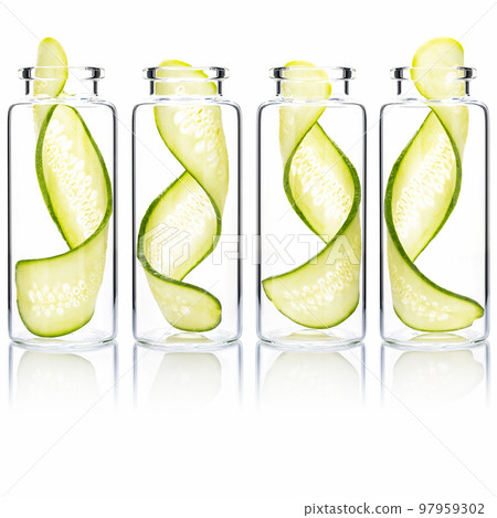 Homemade skin care cucumber slice twist in glass bottles isolated on white background. 97959302