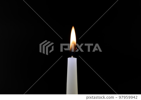 Burning candle in the dark with free copy space 97959942
