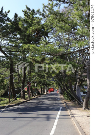 Okayama Okayama City Kibitsu Shrine approach and JR Kibi Line train 97961174