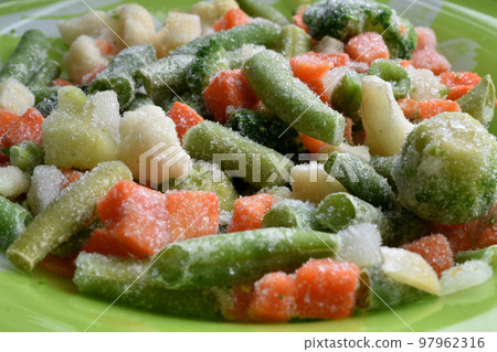 Frozen fresh vegetables, cabbage, carrots on a plate. 97962316