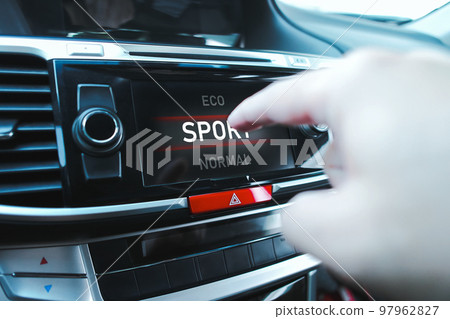 The driver is manually selecting a drive mode The driver is manually selecting a drive mode 97962827