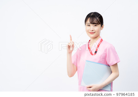 A young female nurse wearing a pink scrub (pointing pose) 97964185