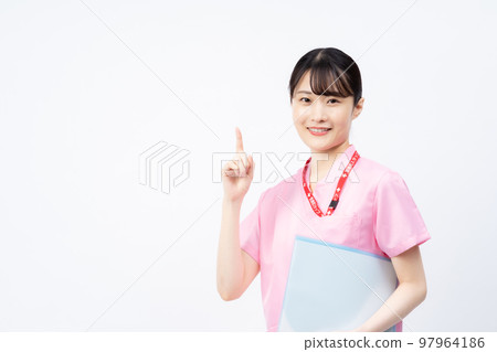 A young female nurse wearing a pink scrub (pointing pose) 97964186