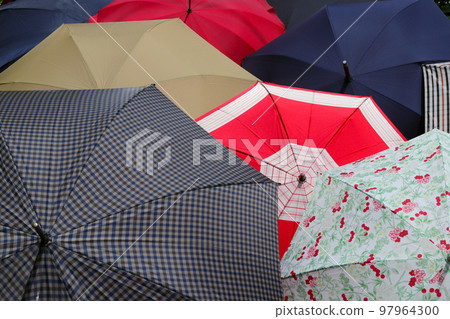 Umbrellas of various colors are comfortably dried in the sun on a sunny day. Umbrellas of various colors are comfortably dried in the sun on a sunny day. 97964300